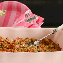 rice and chicken entrée in festive pink passing dish