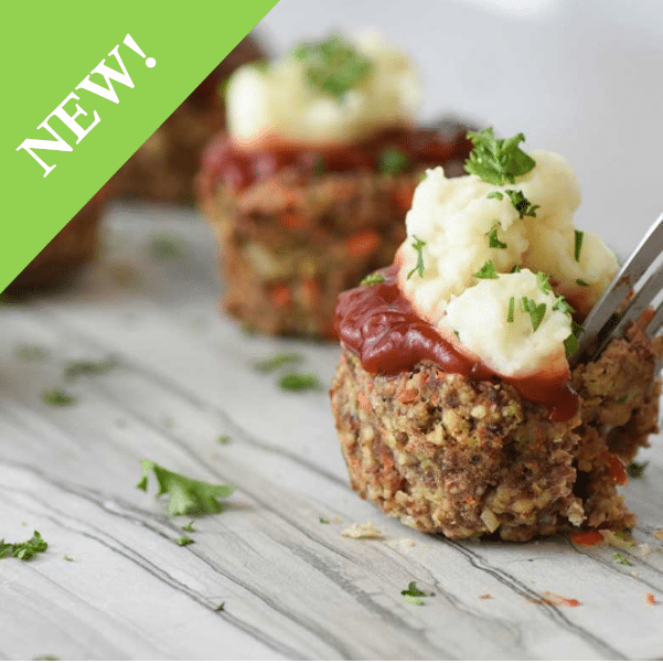 Mealtoaf balls with sauce, mashed potatoes and garnish on top with 'NEW' sticker in corner