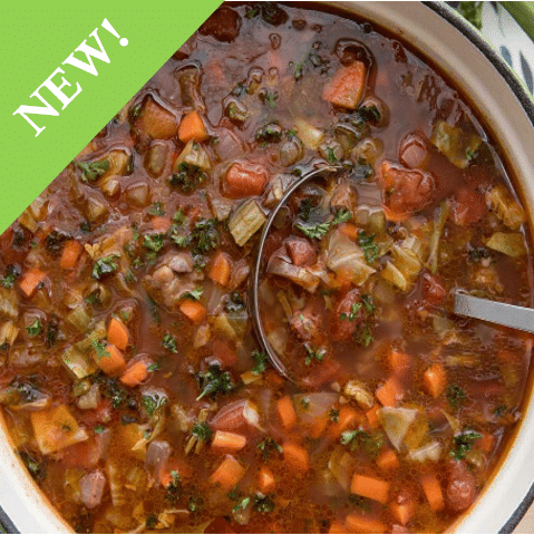 finely chopped vegetable soup in brown broth with ladel