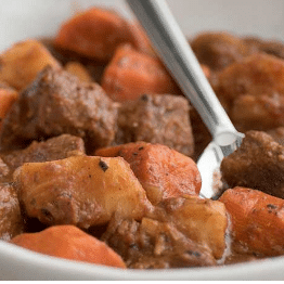 seasoned beef stew in a white bowl