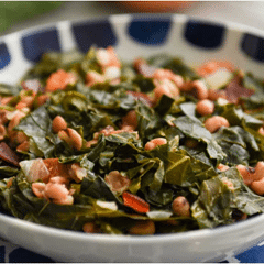 collared greens and black eyed peas in a shallow white and blue bowl